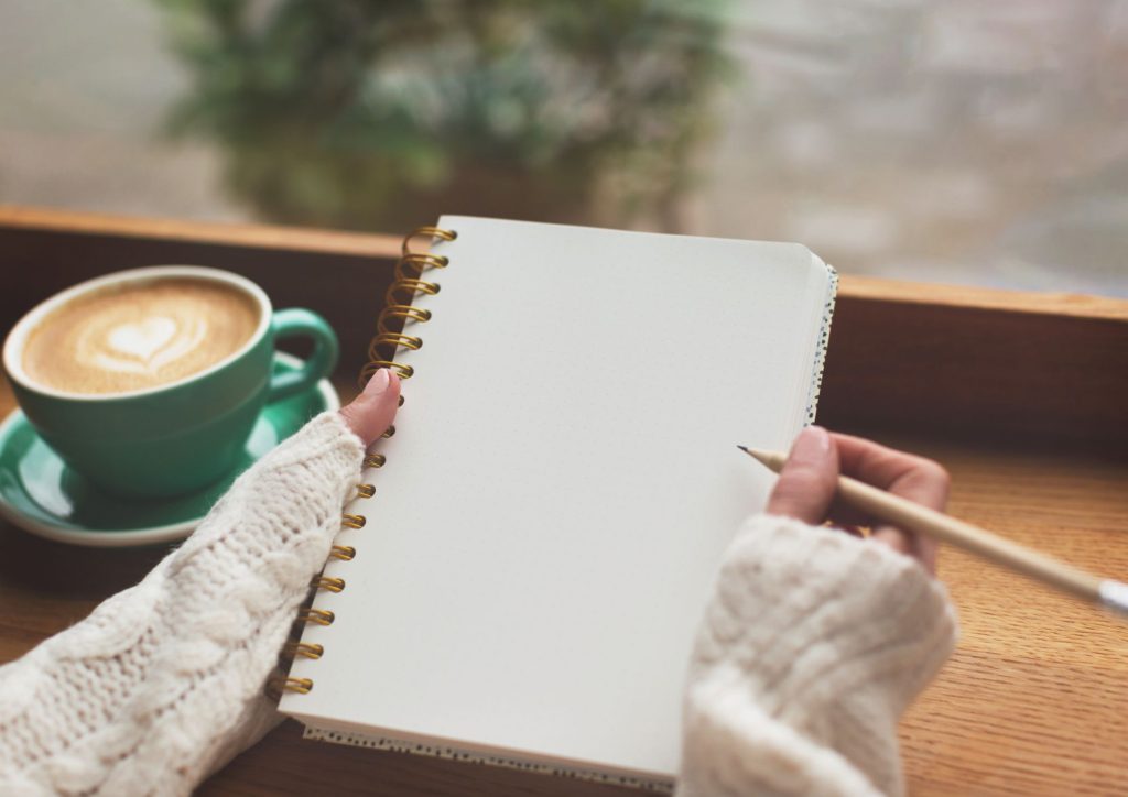hands diary writing self reflection