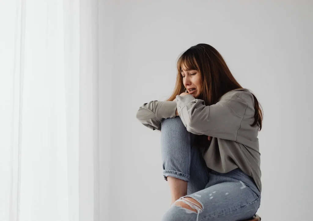 woman feeling helpless and she cries