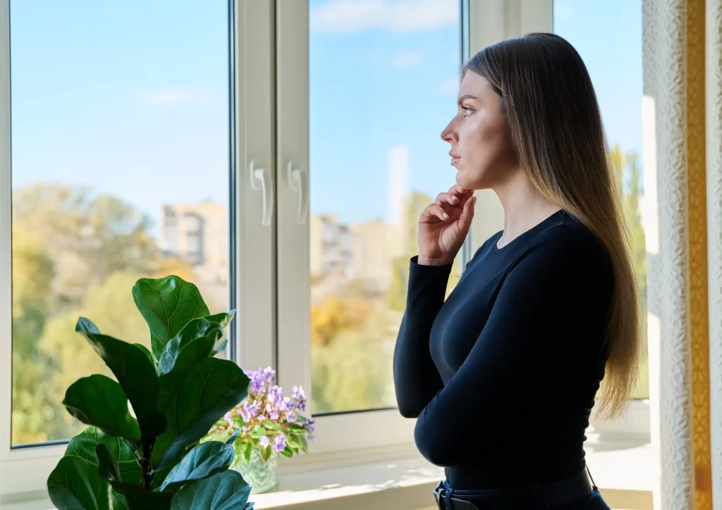 woman looking through window